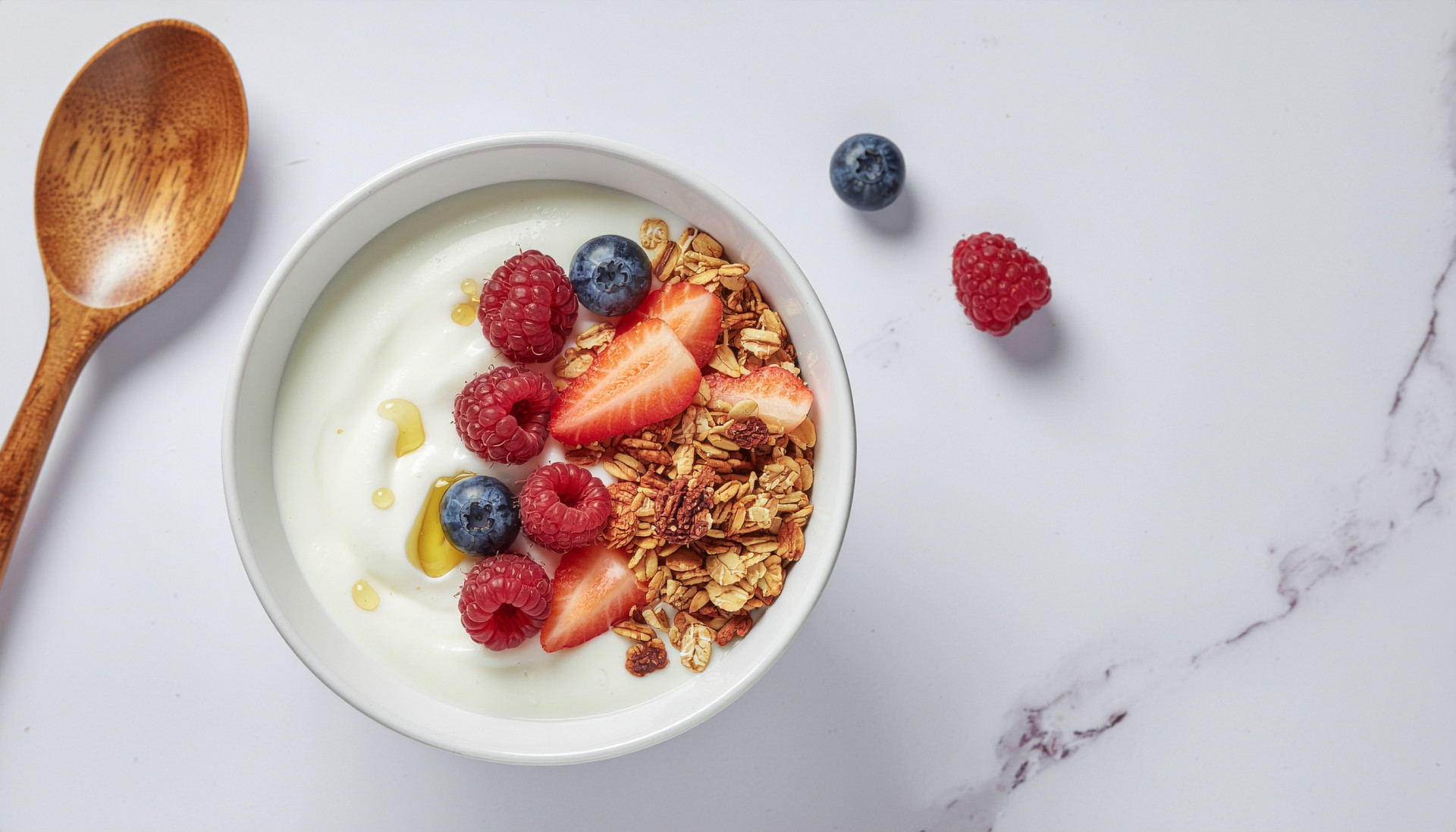 Greek yogurt bowl with fresh berries, honey and granola