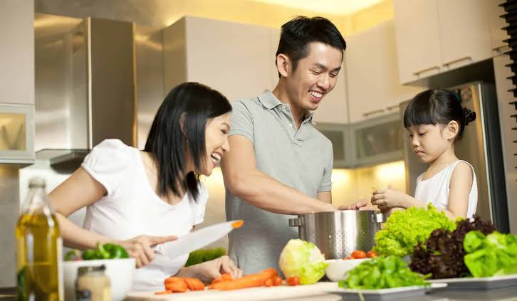 A family cooking together in the kitchen