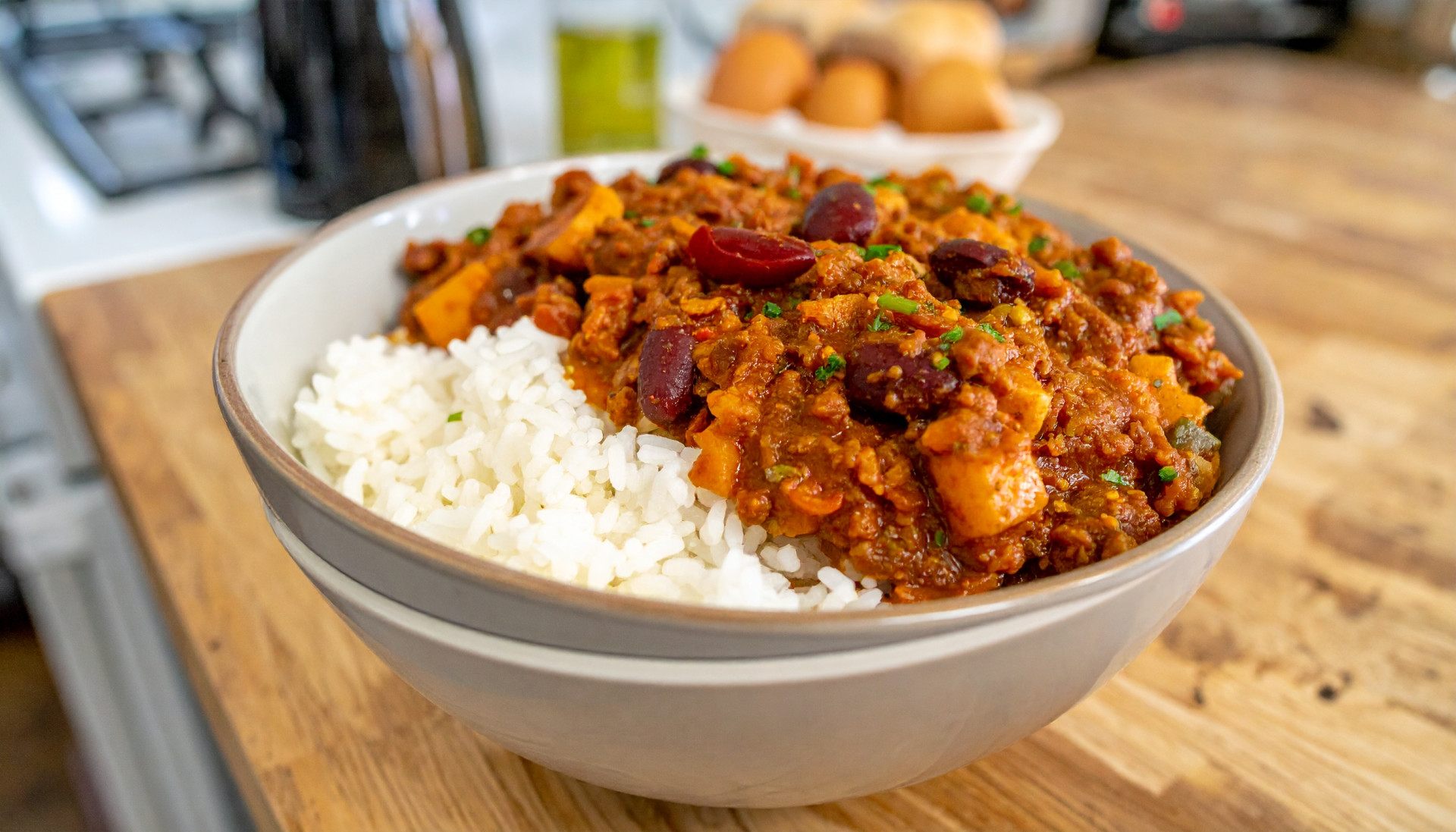 Mild bean chili over rice in a bowl