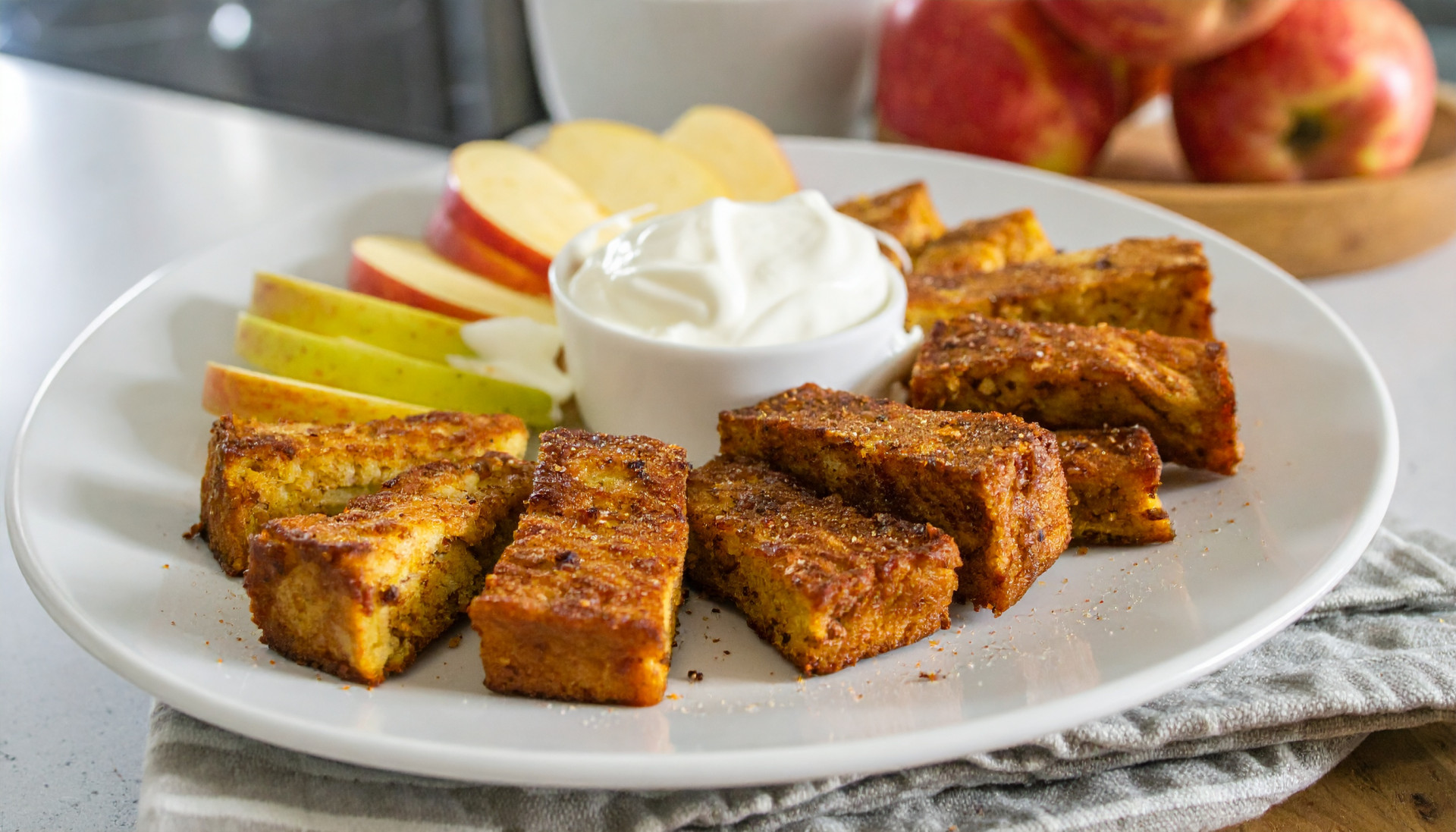 Cinnamon Roll French Toast Bites with sliced apples