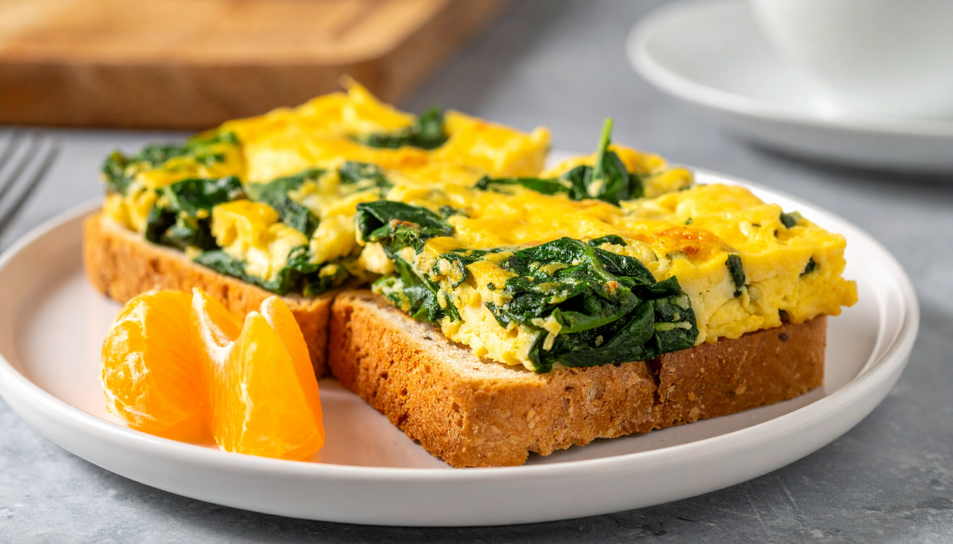 Two cheesy spinach scramble toasts