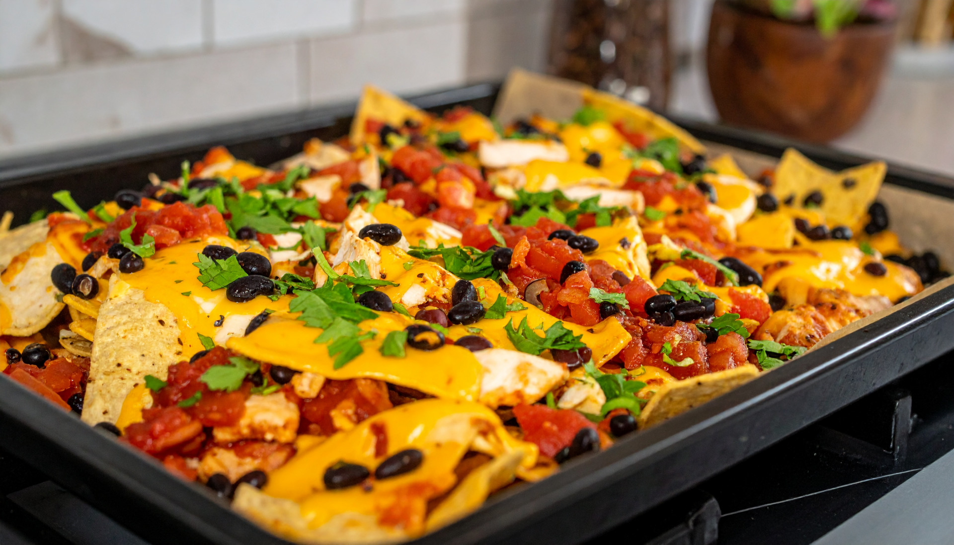 Sheet-pan chicken nachos with black beans and sharp cheddar