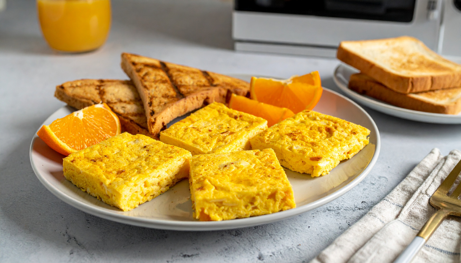 Egg squares with breakfast toast and a mandarin