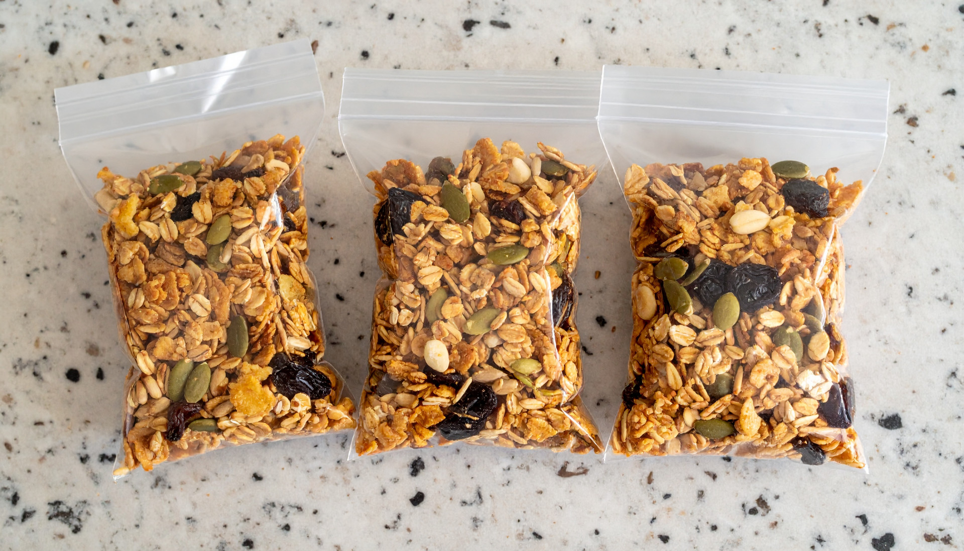Snack mix bags with toasted oat cereal, pumpkin seeds, and raisins